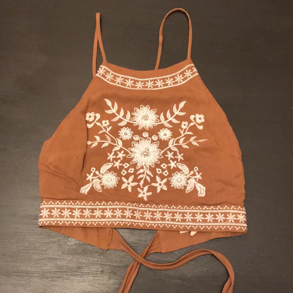 Light brown crop top with a tie in the back.